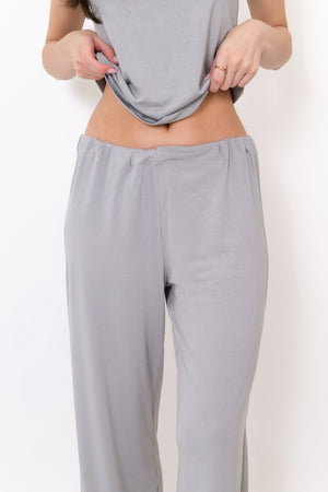 Grey flow pants waist and leg close-up with elastic waistband and drawstring