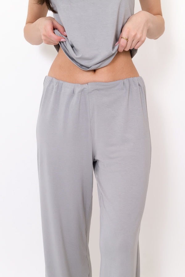 Grey flow pants waist and leg close-up with elastic waistband and drawstring