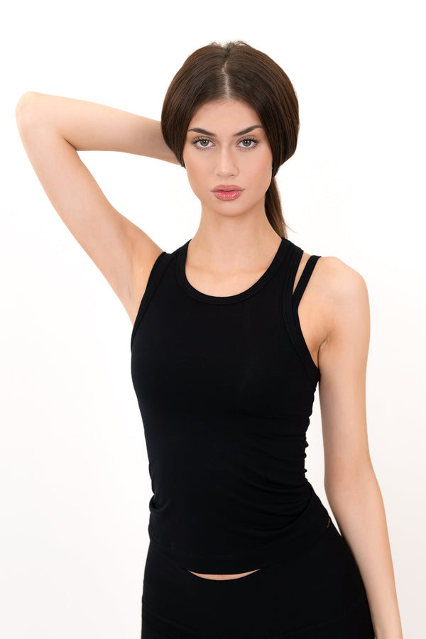 Black essential tank top with crew neck, fitted waist, and small hem slit