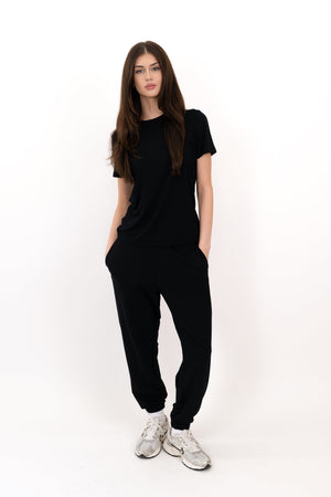 Black sweatpants with relaxed fit and elastic ankle cuffs, small logo on leg
