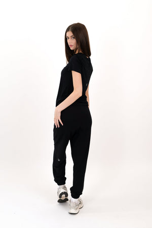 Black sweatpants, side view, relaxed jogger style with elastic ankle cuffs