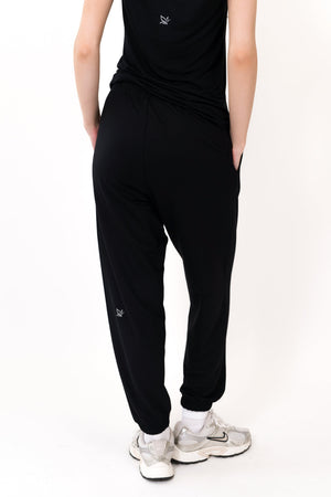 Black sweatpants with tapered relaxed legs and elastic ankle cuffs, small logo detail