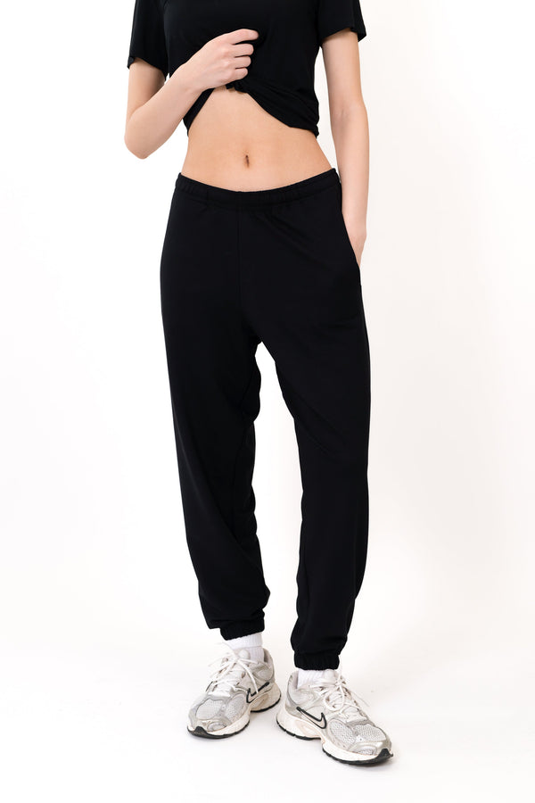 Black sweatpants with elastic waistband and elastic ankle cuffs