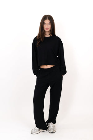 Black wide-leg sweatpants with elastic waistband and roomy relaxed fit