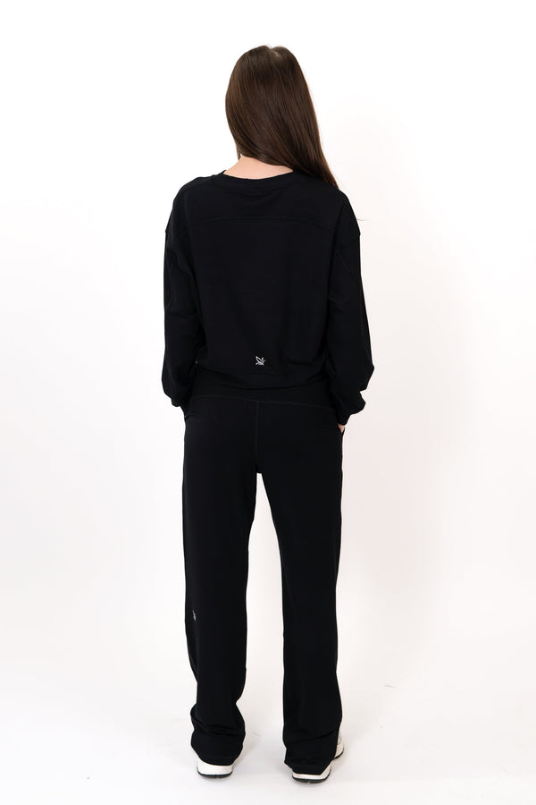 Black crew neck pullover, back view, long sleeves with small chest logo