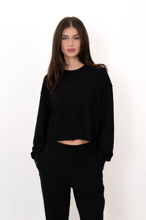 Black crew neck pullover with long sleeves and cropped waist