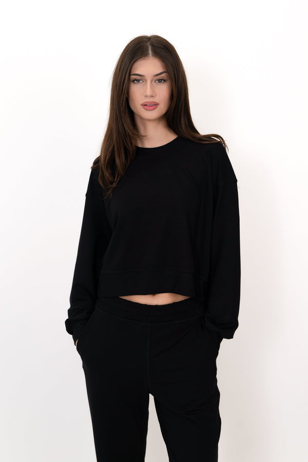 Black crew neck pullover with long sleeves and cropped waist