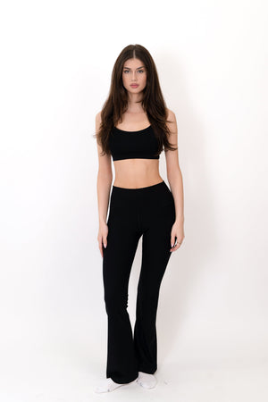 Black flare legging with high-rise waistband and smooth straight-to-bootcut legs.
