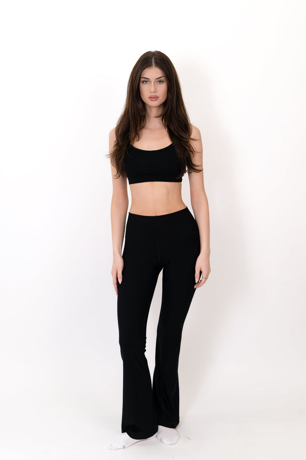 Black flare legging with high-rise waistband and smooth straight-to-bootcut legs.