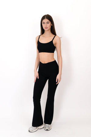 Black flare legging front view, high-rise waist and full-length bootcut silhouette.