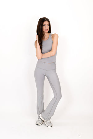 Gray flare legging with high-rise fit and smooth tapered bootcut legs.