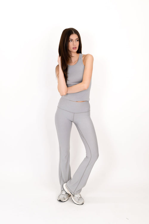 Gray flare legging with high-rise fit and smooth tapered bootcut legs.