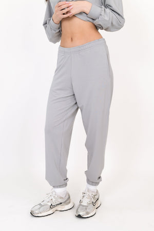 Gray sweatpants with elastic waistband and relaxed tapered fit