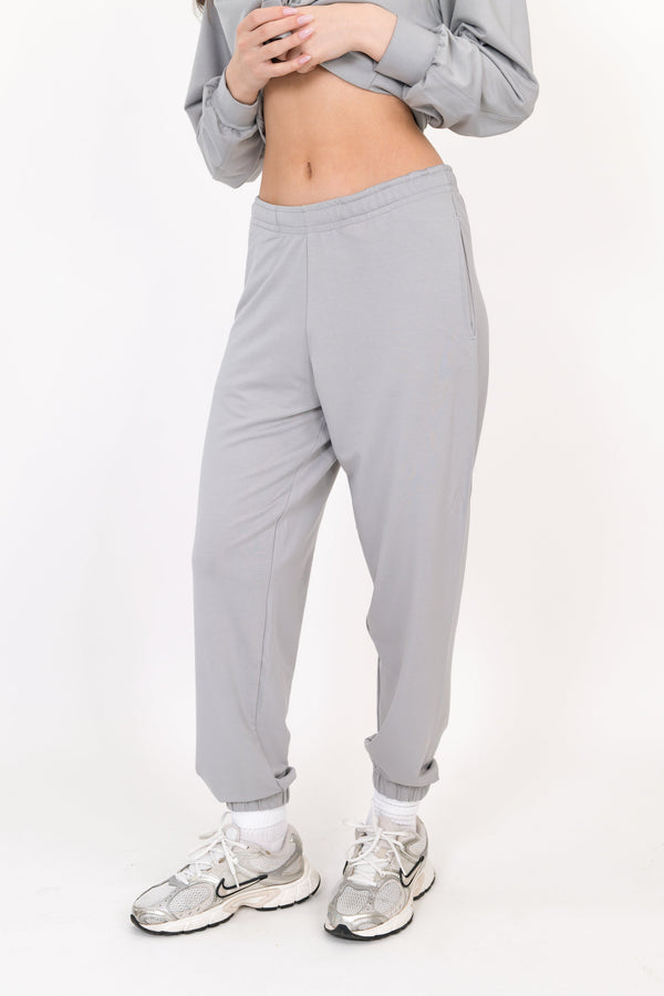 Gray sweatpants with elastic waistband and relaxed tapered fit