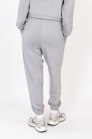 Gray sweatpants with side seams and tapered cuffed ankles