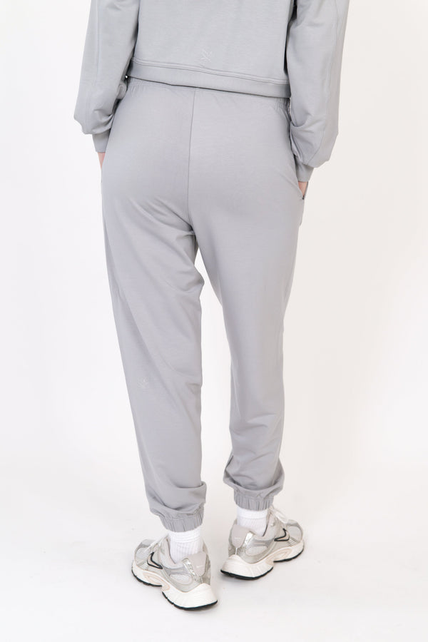 Gray sweatpants with side seams and tapered cuffed ankles