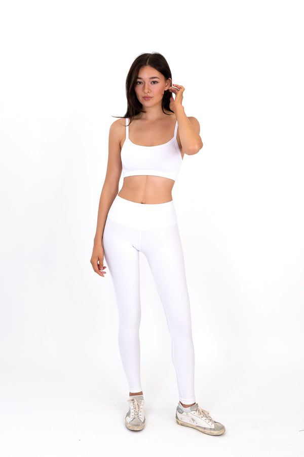 White high-rise leggings with wide waistband and full-length fitted legs