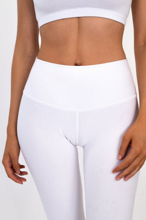 White high-rise leggings with wide waistband and smooth supportive fabric