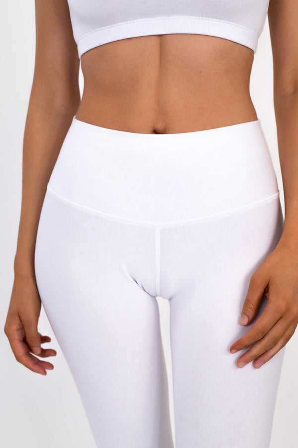 White high-rise leggings with wide waistband and smooth supportive fabric