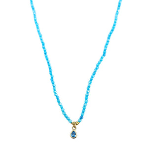 Turquoise beaded necklace with two goldtone teardrop charms and faceted center stones