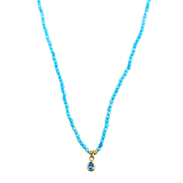 Turquoise beaded necklace with two goldtone teardrop charms and faceted center stones