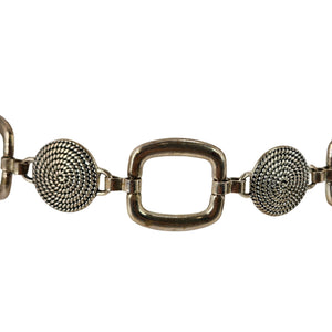 Silver-toned chain belt close-up: square link buckle with textured round medallion discs