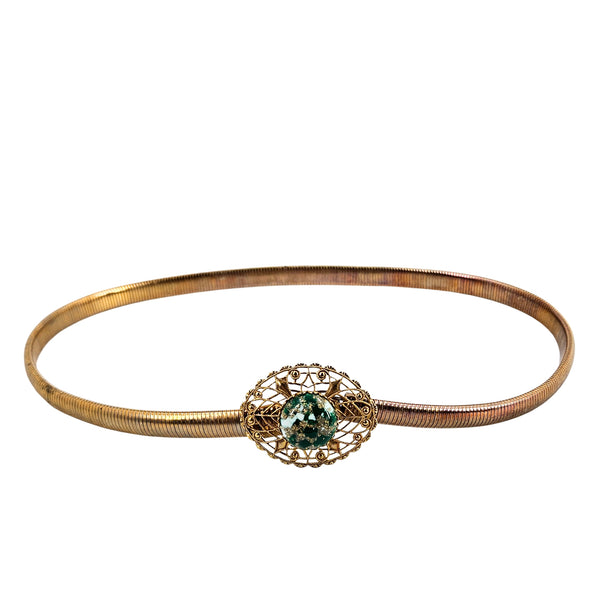 Gold-tone snake chain bracelet with filigree clasp and green gemstone