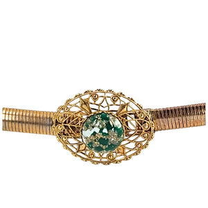 Gold-tone filigree buckle with green faceted gemstone on snake chain