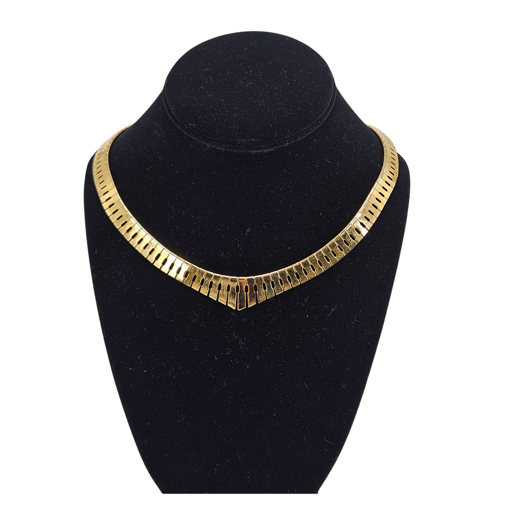 Gold vintage-style collar necklace with textured links and fringe detail