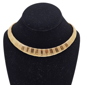 Gold textured collar necklace with ribbed segments shown on dark display bust