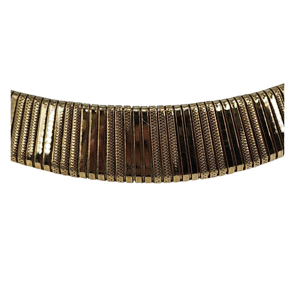 Gold textured collar necklace detail of ribbed panels and segmented links