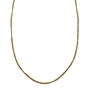 Gold chain necklace with fine curb links, curved around the neckline