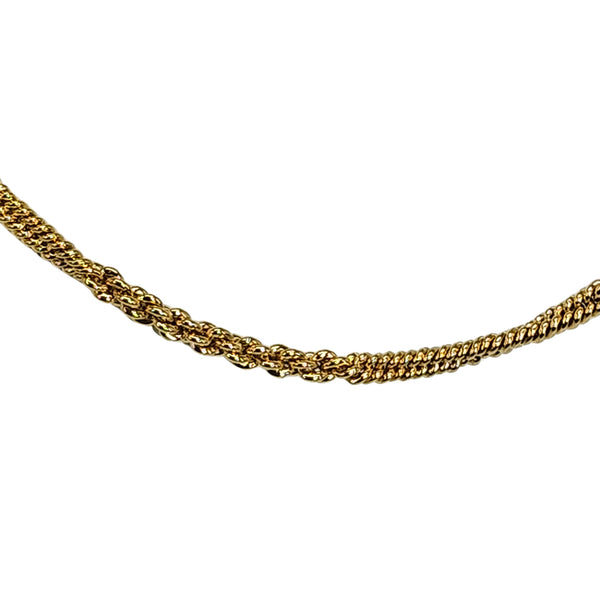 Gold curb-chain necklace close-up, interlocking link pattern