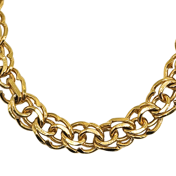 Gold chain choker necklace close-up of interlocking links and curved profile