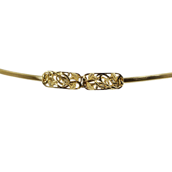 Gold vintage costume belt with center filigree buckle and ribbed stretch band.