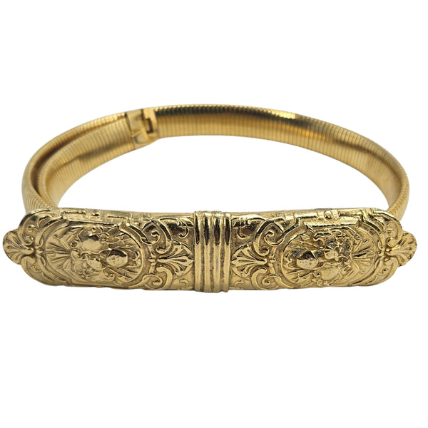 Gold stretch belt with engraved floral motifs on central oval panel and arched band