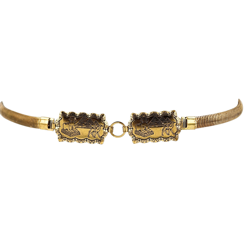 Gold stretch belt with Egyptian revival brass plaques and circular link clasp.