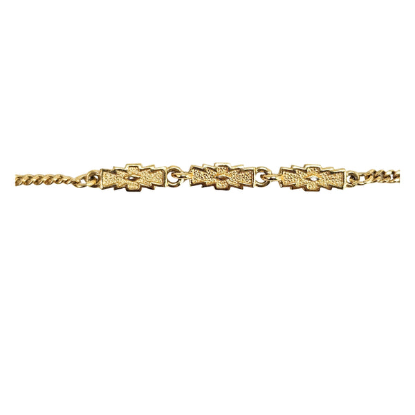 Gold-tone station necklace detail: rectangular links with star accents on double chain