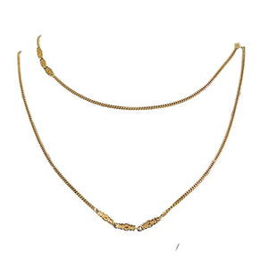 Gold-tone long station link chain necklace with curved silhouette and repeating stations