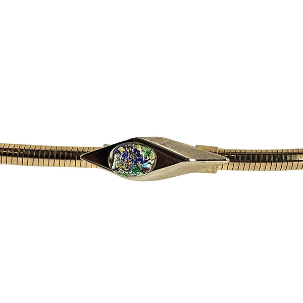 Close-up of the gold-tone belt's geometric buckle and multicolor cabochon