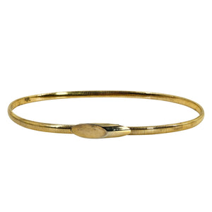 Gold-tone stretch snake chain belt with oval clasp, shown in a full loop.