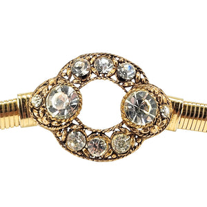 Gold tone circle buckle with large clear rhinestone stones and halo detail