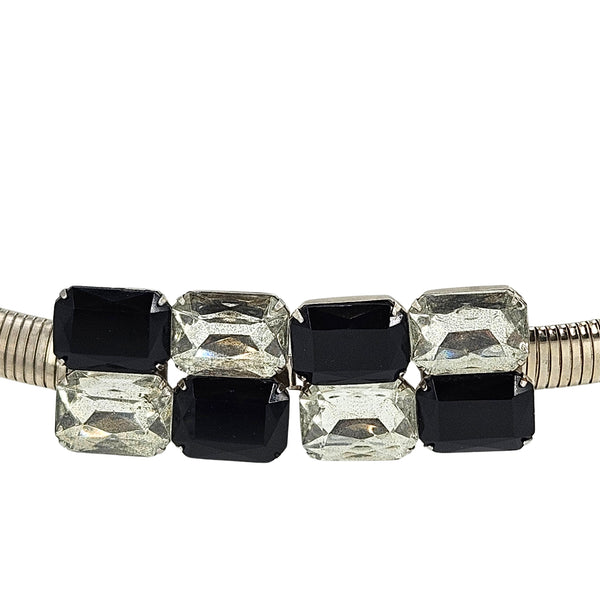 Rhinestone buckle close-up on silver tone stretch belt with black and clear faceted stones