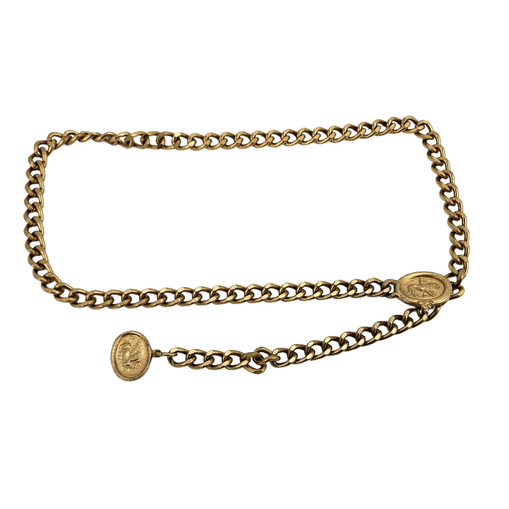 Gold chain belt with oval coin-style medallion buckle and linked waist chain