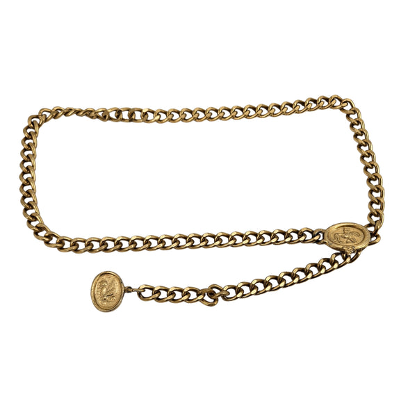 Gold chain belt with oval coin-style medallion buckle and linked waist chain