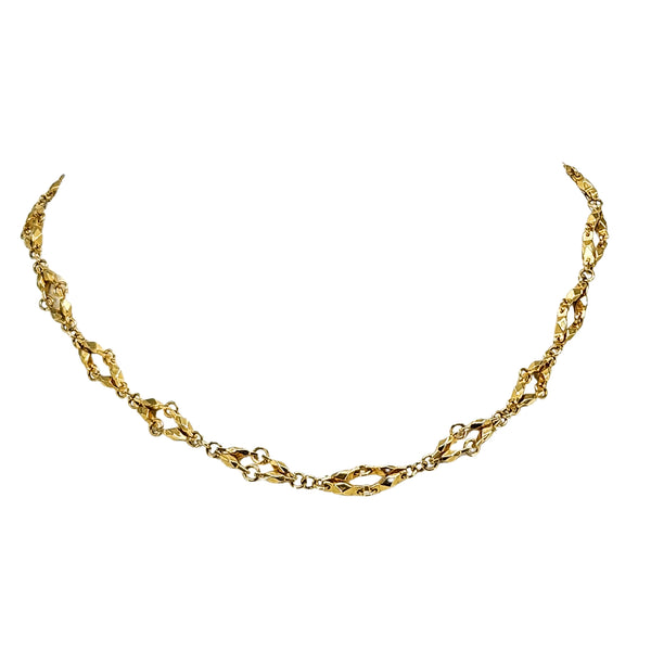 Gold diamond-link chain necklace with faceted links and central curved section