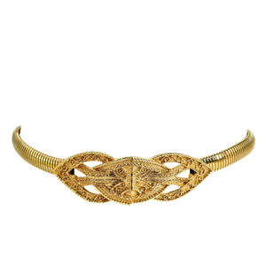 Gold stretch belt with curved interlocking filigree buckle, side profile view