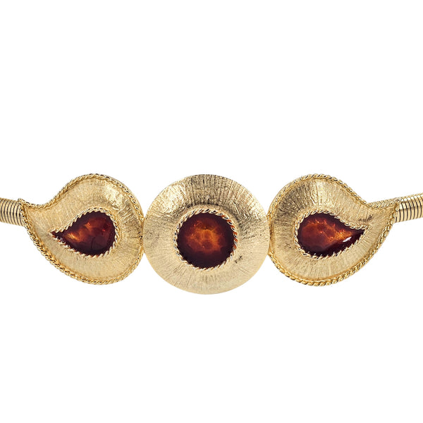 Goldtone snake coil belt close-up with three red-brown cabochon gemstone settings