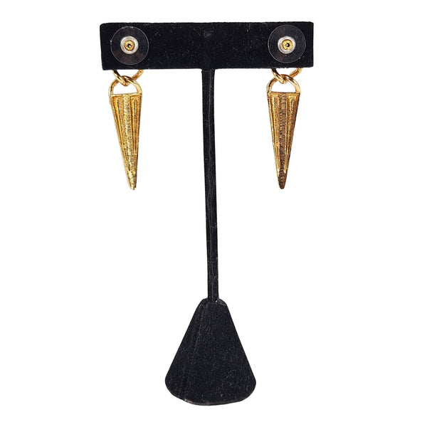 Gold-tone earrings with purple enamel shield accents and pointed teardrop dangles
