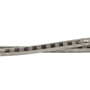 Close-up of silver snake chain belt with black rectangular accent pattern